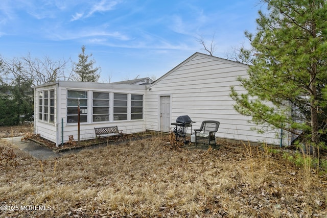 rear view of property with a sunroom