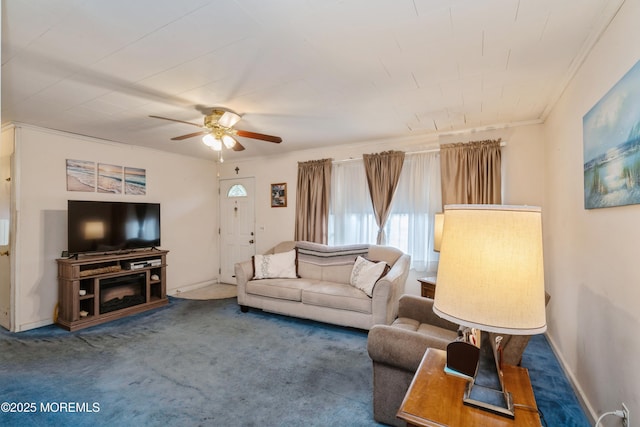 living room featuring ceiling fan, ornamental molding, and dark colored carpet