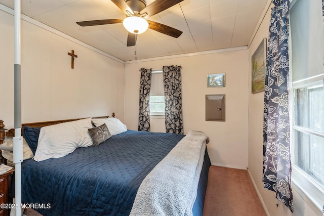 carpeted bedroom featuring ornamental molding, electric panel, and ceiling fan