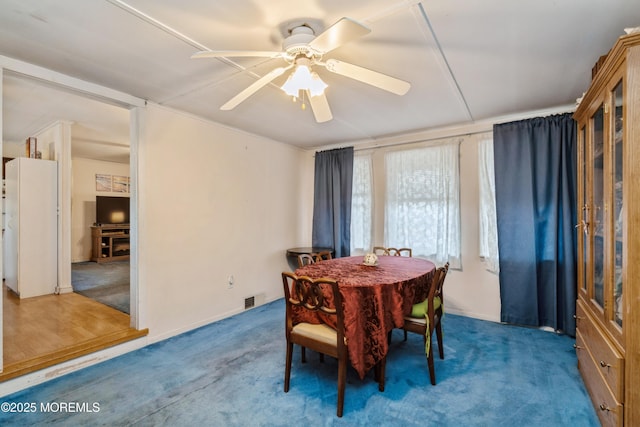 dining room with ceiling fan and carpet