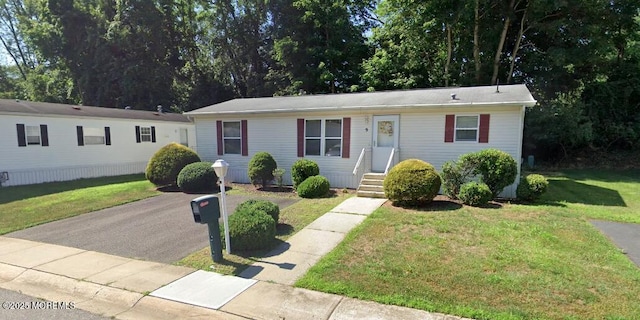 ranch-style home with a front lawn