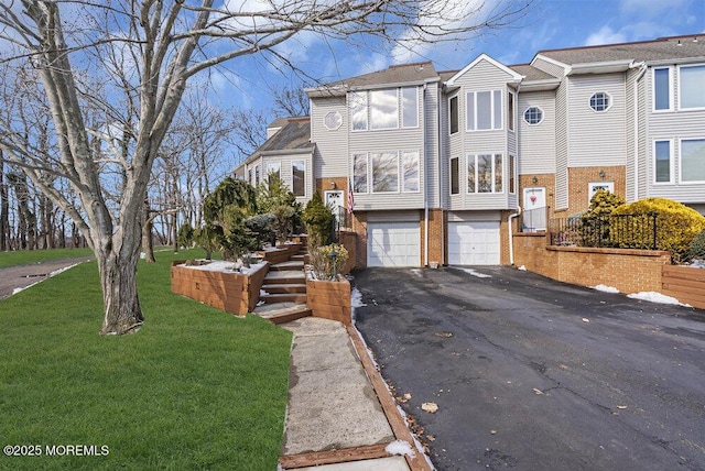 view of front of home with a garage and a front yard