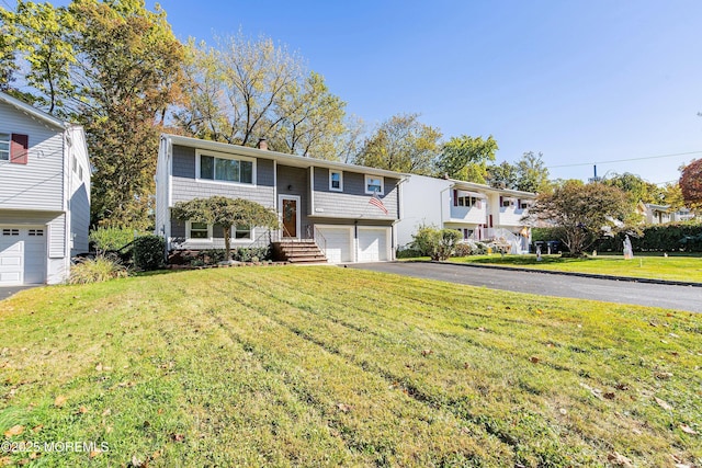 raised ranch with a garage and a front lawn