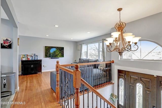 entryway featuring recessed lighting, wood finished floors, an inviting chandelier, and baseboards