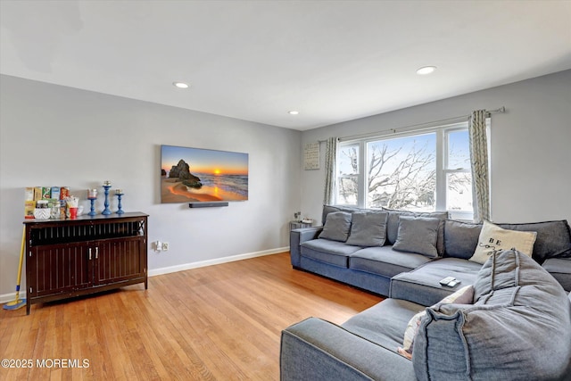 living room with light wood-style floors, baseboards, and recessed lighting