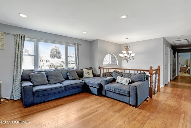 living room featuring a chandelier, wood finished floors, and recessed lighting