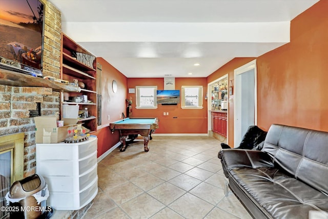 game room with a large fireplace, billiards, baseboards, and light tile patterned floors