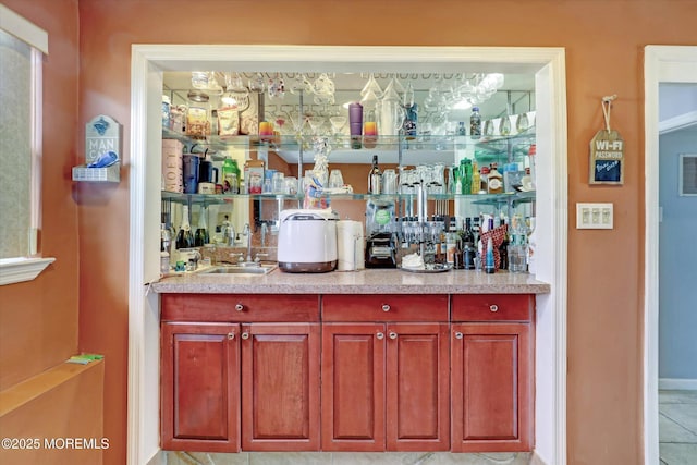 bar featuring a bar, a sink, and visible vents