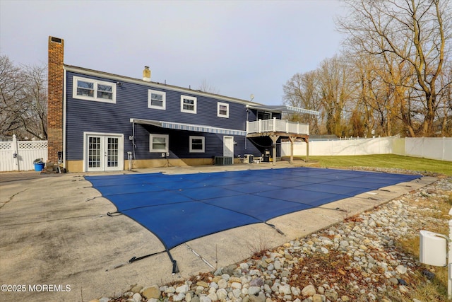 view of pool featuring french doors, a patio area, fence, and a fenced in pool