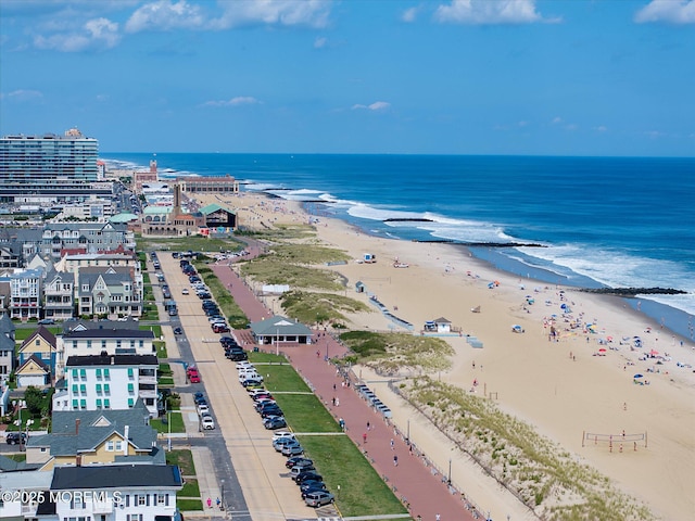 drone / aerial view with a water view and a beach view