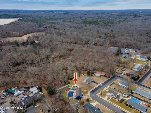 bird's eye view featuring a forest view