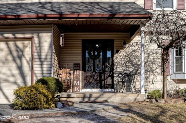 property entrance featuring a garage and a porch