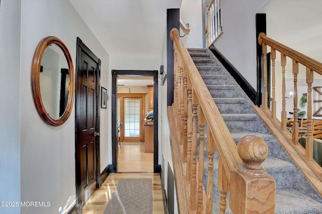 staircase with wood-type flooring