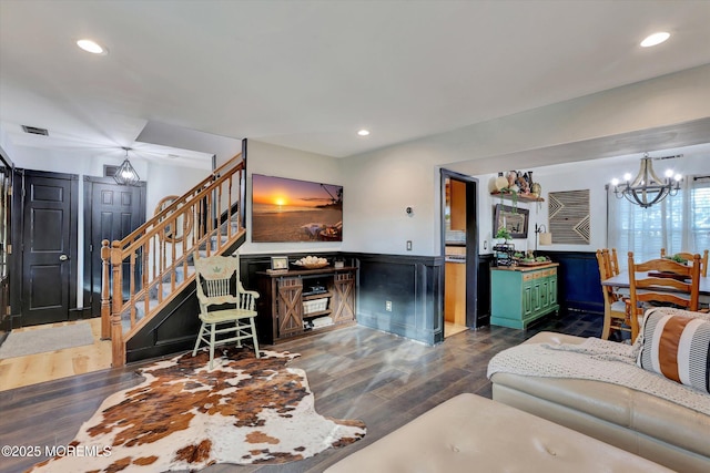 living room with a notable chandelier and dark hardwood / wood-style flooring