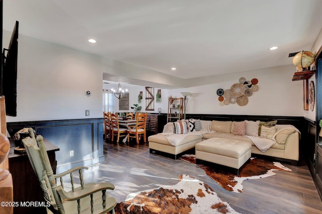 living room featuring dark wood-type flooring and a chandelier