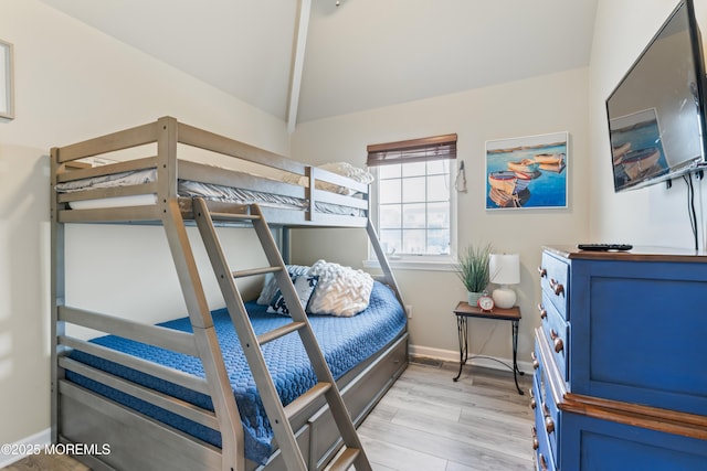 bedroom with vaulted ceiling and light hardwood / wood-style floors