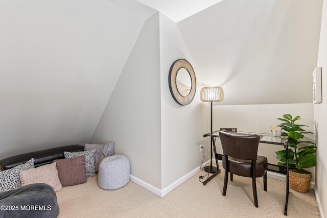 carpeted office space featuring lofted ceiling