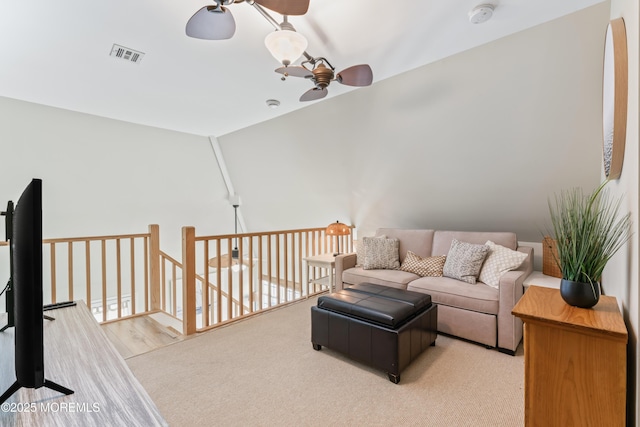 living room featuring ceiling fan and light colored carpet