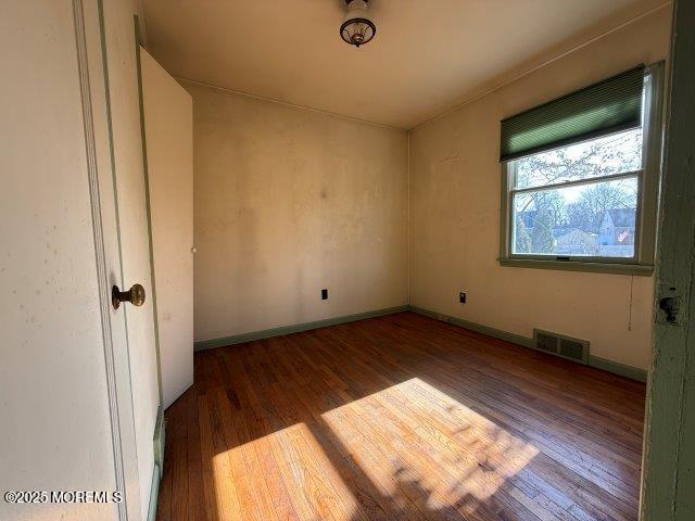 unfurnished room featuring hardwood / wood-style floors