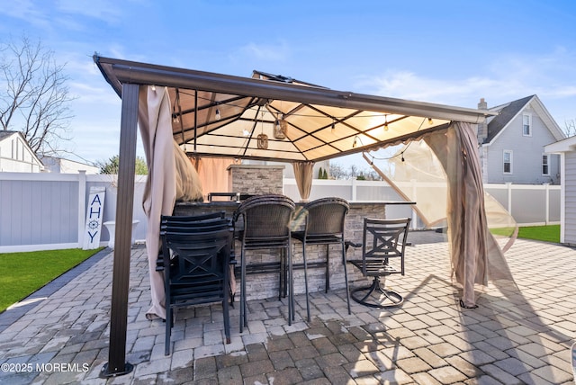 view of patio featuring a gazebo and exterior bar