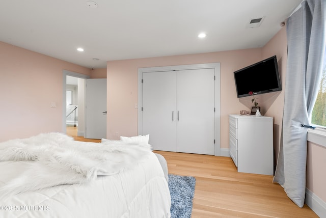 bedroom featuring a closet and light wood-type flooring