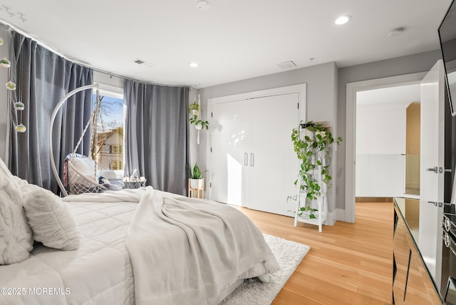 bedroom featuring wood-type flooring and a closet