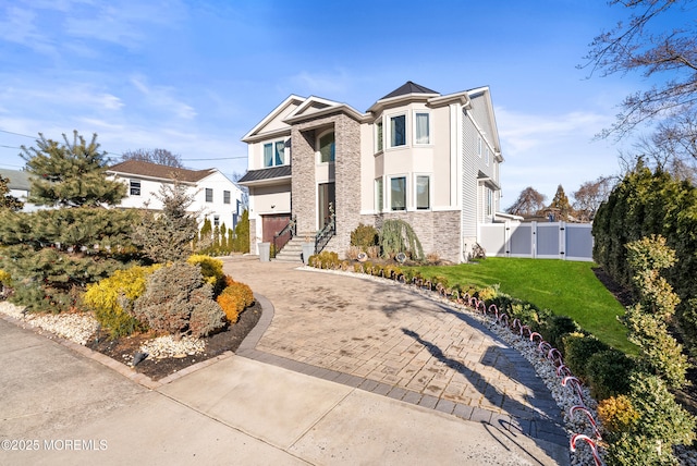 view of front of house featuring a garage and a front lawn