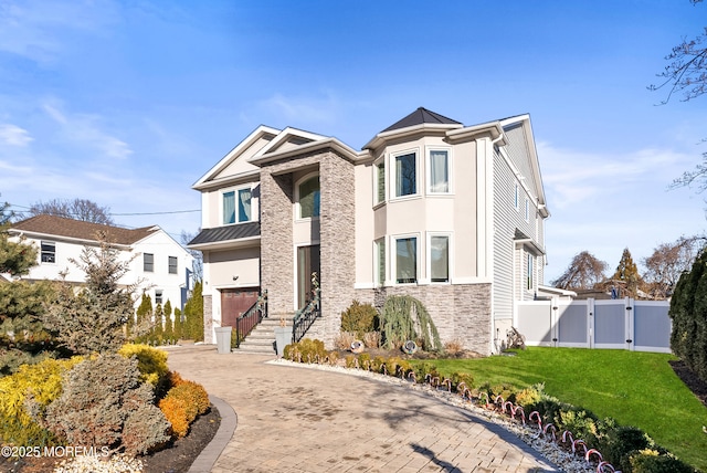 view of front facade featuring a garage and a front lawn