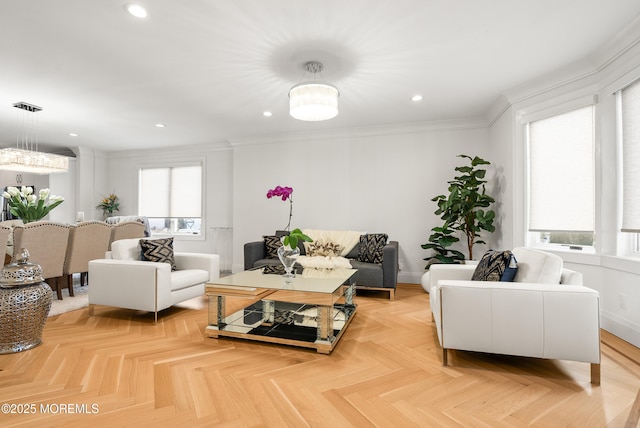 living room with crown molding, light parquet flooring, and plenty of natural light