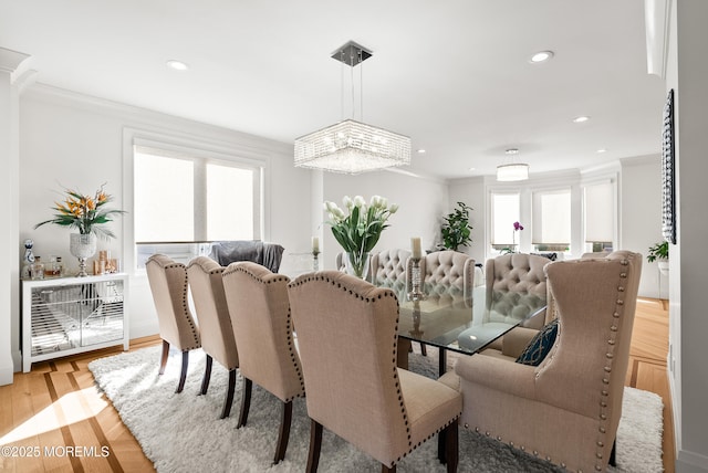 dining room featuring crown molding and light hardwood / wood-style floors