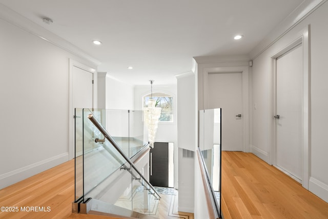 corridor featuring crown molding and light wood-type flooring