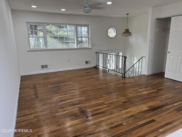 unfurnished room with ceiling fan and dark hardwood / wood-style flooring