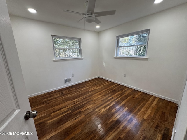 unfurnished room with ceiling fan and dark hardwood / wood-style flooring