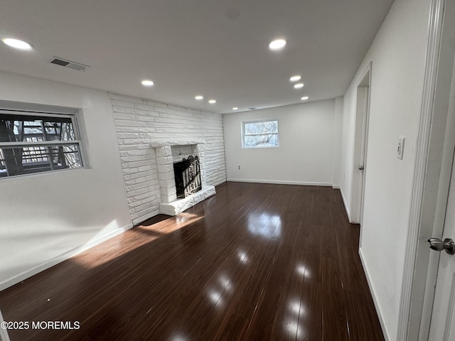 unfurnished living room with dark hardwood / wood-style floors and a fireplace