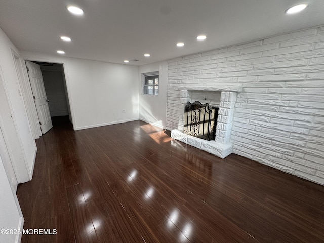 unfurnished living room with a fireplace and dark hardwood / wood-style flooring