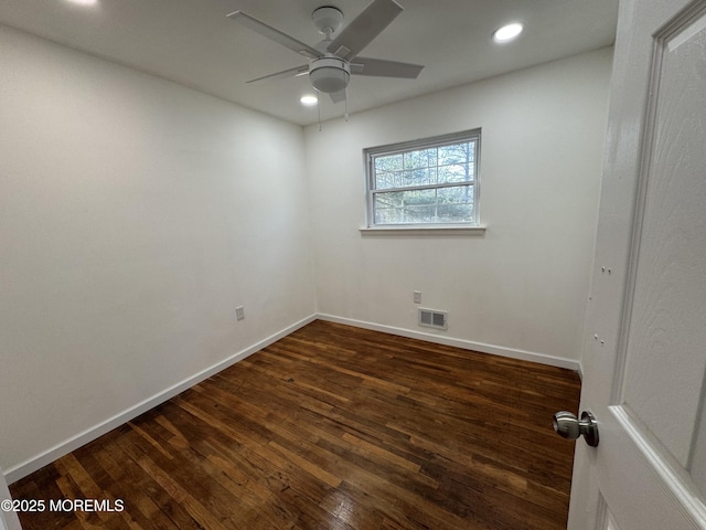 empty room featuring dark wood-type flooring and ceiling fan