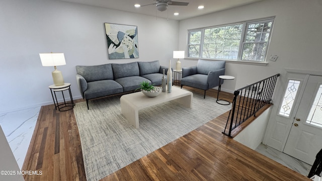 living room with hardwood / wood-style flooring and ceiling fan