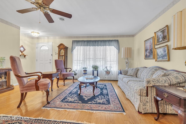 living room with ceiling fan and light hardwood / wood-style flooring