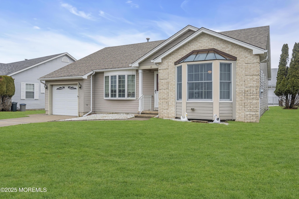 view of front facade with a garage and a front yard