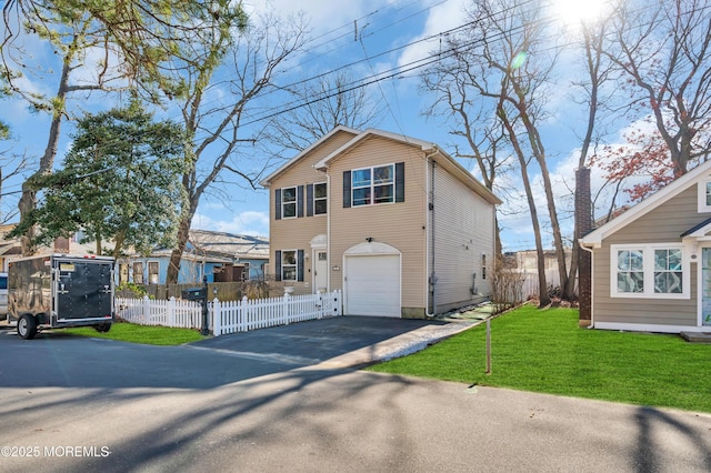 view of front of home with a garage and a front yard