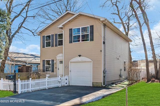 front facade featuring a garage and a front yard