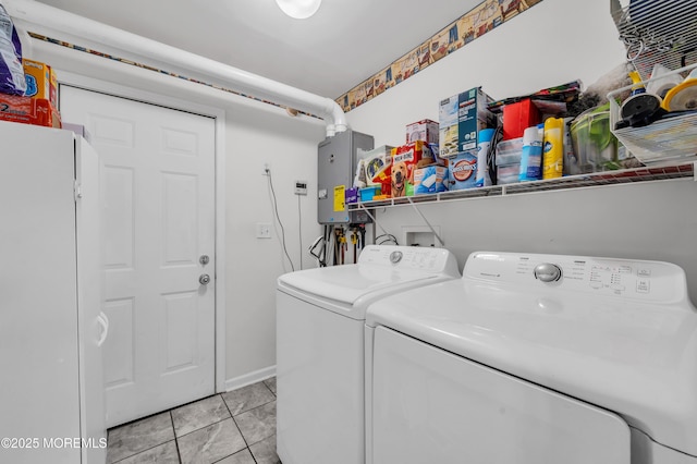 washroom featuring washing machine and dryer and light tile patterned floors