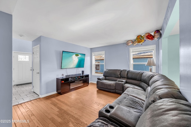 living room featuring a wealth of natural light and light wood-type flooring