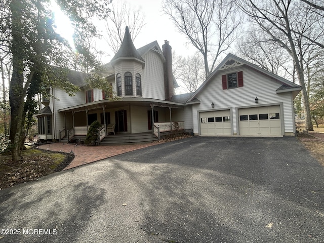 view of front of house featuring a garage and covered porch