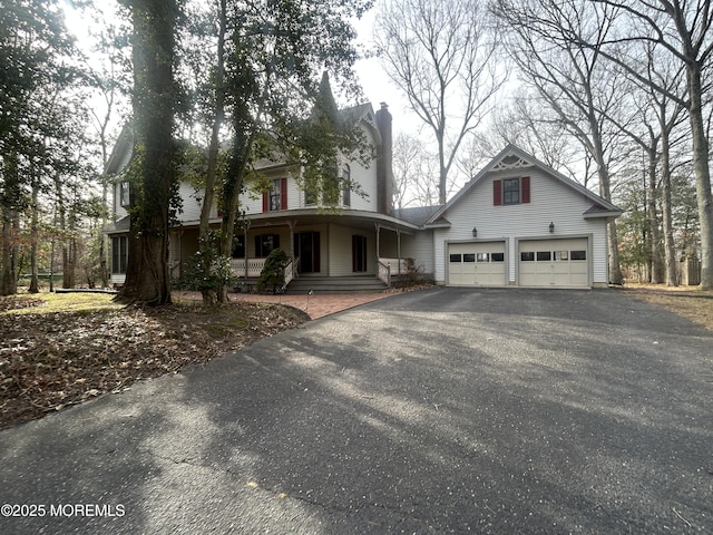 front of property with a garage and covered porch