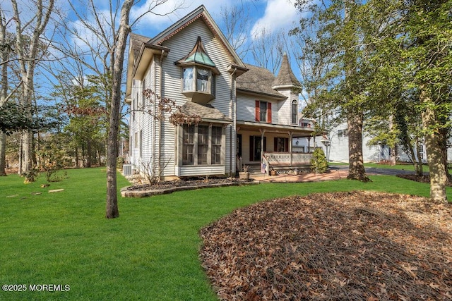 rear view of house with a yard and covered porch