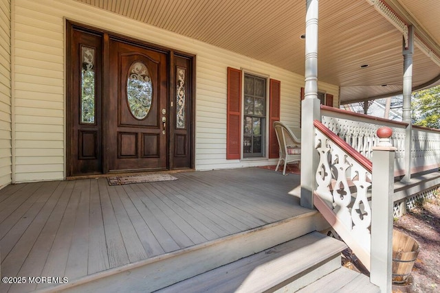 view of exterior entry with covered porch