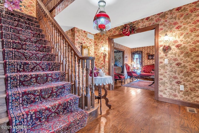 stairs featuring wood-type flooring