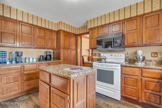 kitchen with dark wood-type flooring, light stone countertops, a center island, and white range with electric cooktop