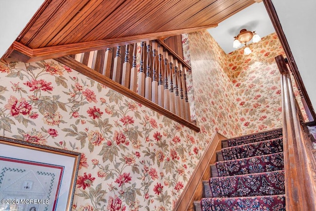 stairway with wood ceiling